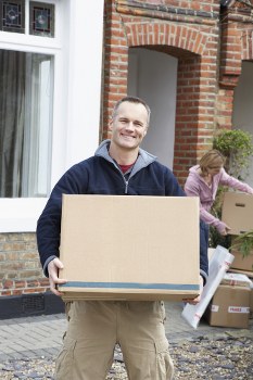 Moving boxes and furniture during Battersea removals in a London residential street